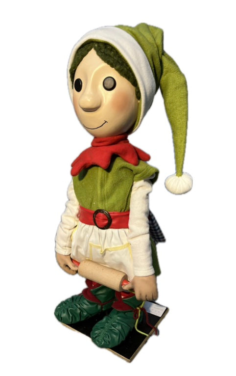Elf with button eyes rolls out dough (Christmas bakery)
