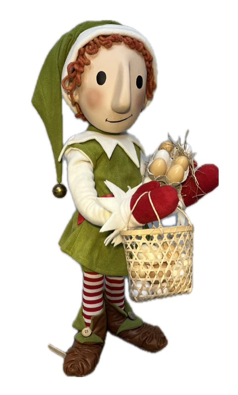 Elf with button eyes brings eggs for dough making (Christmas baking) 