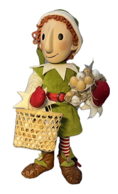 Elf with button eyes brings eggs for dough making (Christmas baking) 