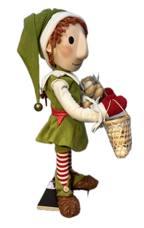Elf with button eyes brings eggs for dough making (Christmas baking) 