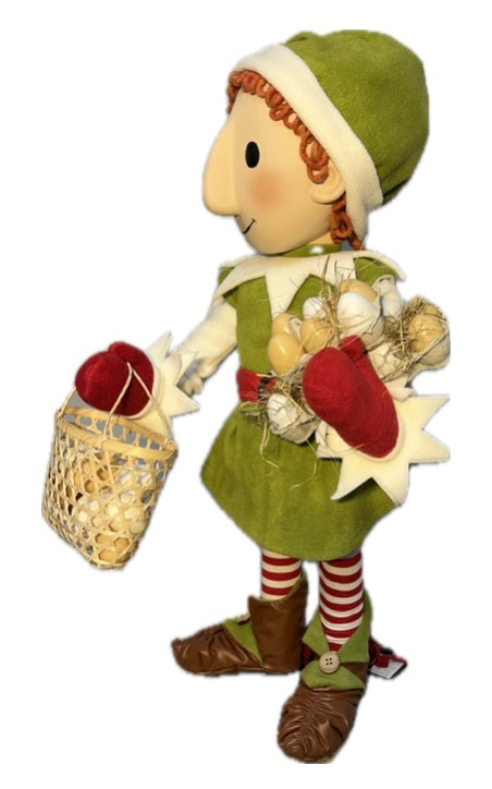Elf with button eyes brings eggs for dough making (Christmas baking) 