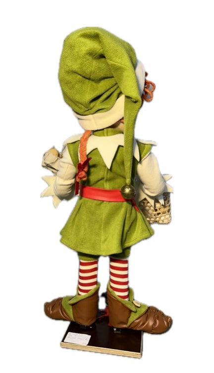 Elf with button eyes brings eggs for dough making (Christmas baking) 