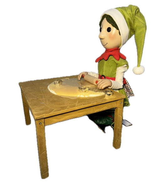 Elf with button eyes rolls out dough (Christmas bakery) 