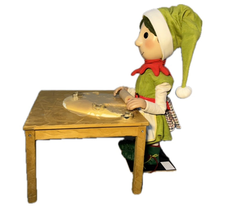 Elf with button eyes rolls out dough (Christmas bakery) 