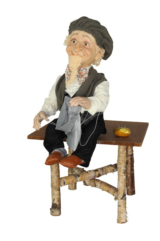 Little tailor on the table from the fairy tale "The Brave Little Tailor"